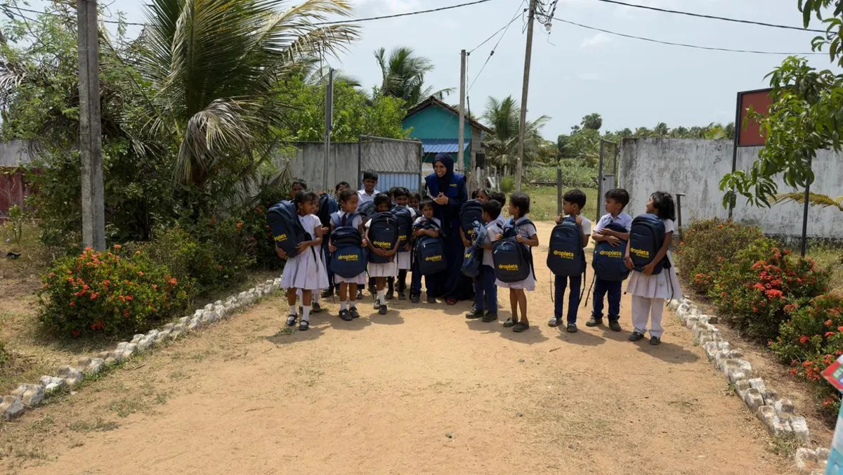 Children receiving school backpacks